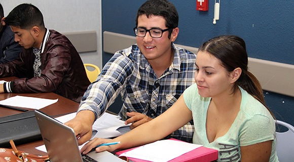 College students in tutoring session on a laptop