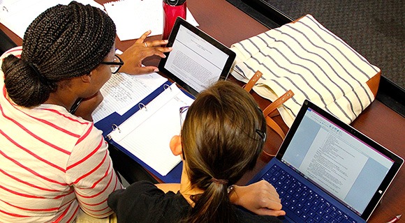 Two community college students collaborating on an essay